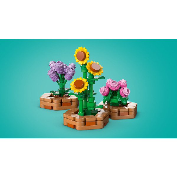 Блоковий конструктор LEGO Friends Будиночок і квітник бджолярів (42669)